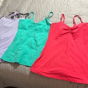 three lululemon shirts two size 8 and the purple size 10